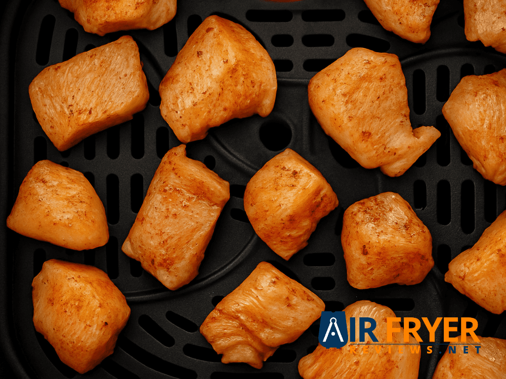 Golden air-fried chicken bites in a bowl.