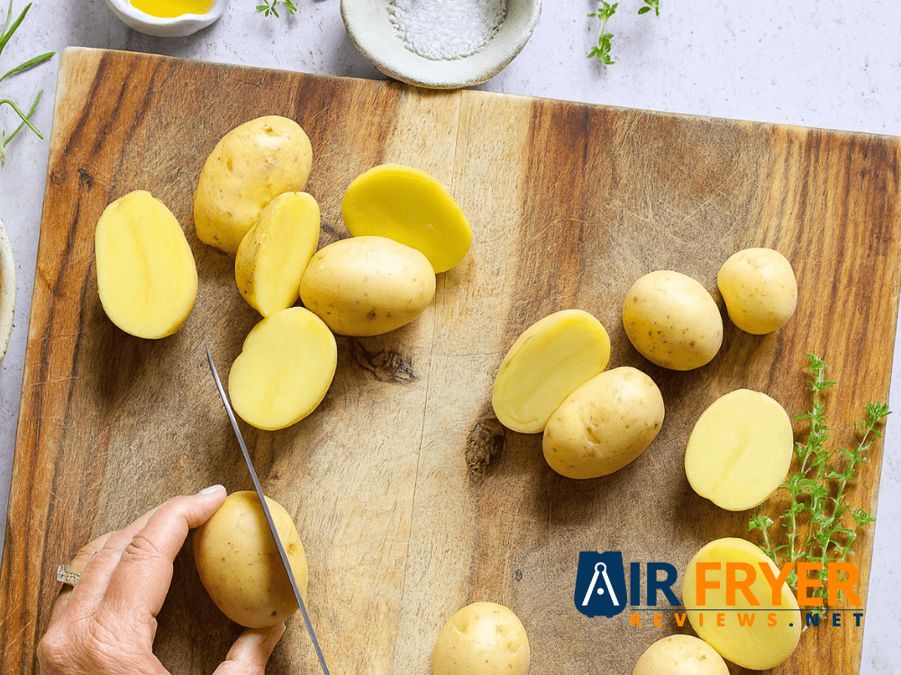Golden roasted potato slices in an air fryer basket with seasoning Air Fryer Reviews