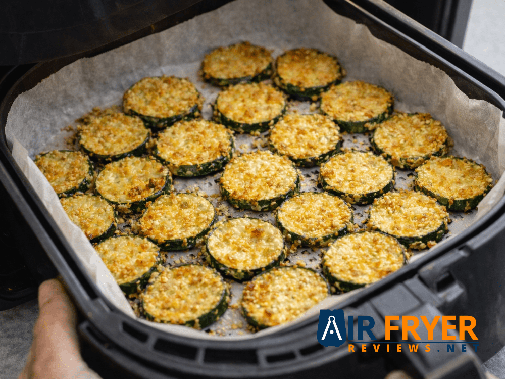 Zucchini chips cooking in air fryer with parchment paper Air Fryer Reviews